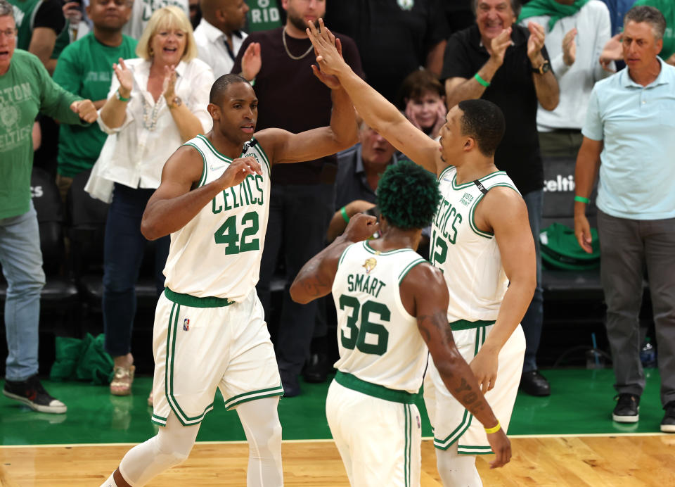 BOSTON, MASSACHUSETTS - JUNE 08: Al Horford #42 of the Boston Celtics reacts after a play with teammates Marcus Smart #36 and Grant Williams #12 in the first quarter against the Golden State Warriors during Game Three of the 2022 NBA Finals at TD Garden on June 08, 2022 in Boston, Massachusetts. The Boston Celtics won 116-100. NOTE TO USER: User expressly acknowledges and agrees that, by downloading and/or using this photograph, User is consenting to the terms and conditions of the Getty Images License Agreement. (Photo by Maddie Meyer/Getty Images)