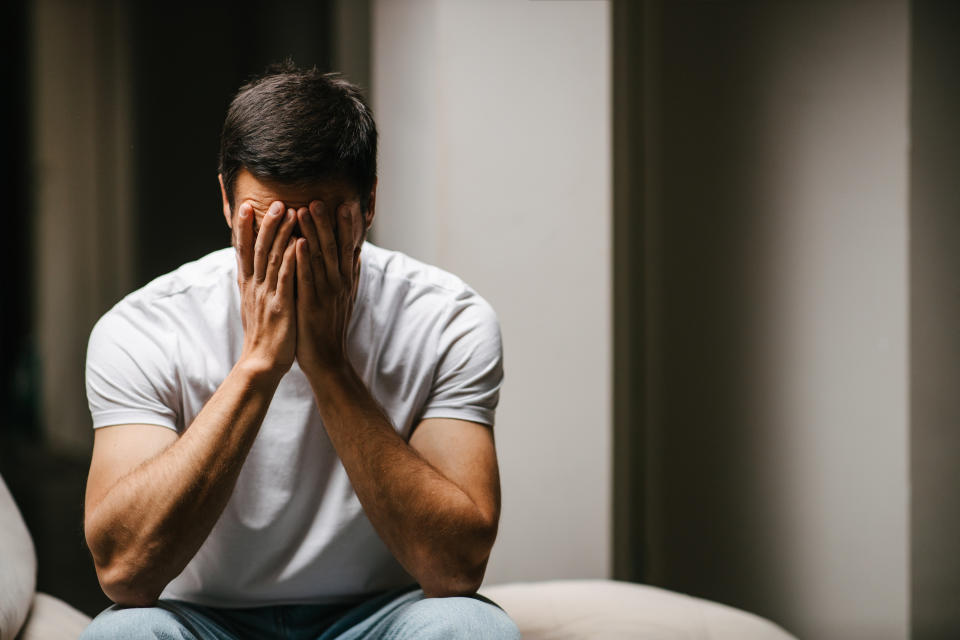 A man sitting with his head in his hands