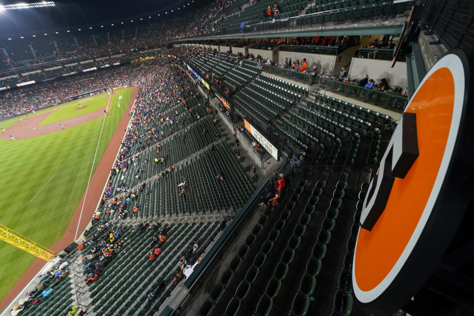 The retired number of Baltimore Orioles Hall of Fame third baseman Brooks Robinson is visible as a crowd watches the seventh inning of a baseball game between the Orioles and the Washington Nationals, Tuesday, Sept. 26, 2023, in Baltimore. Robinson died on Tuesday at the age of 86. (AP Photo/Julio Cortez)