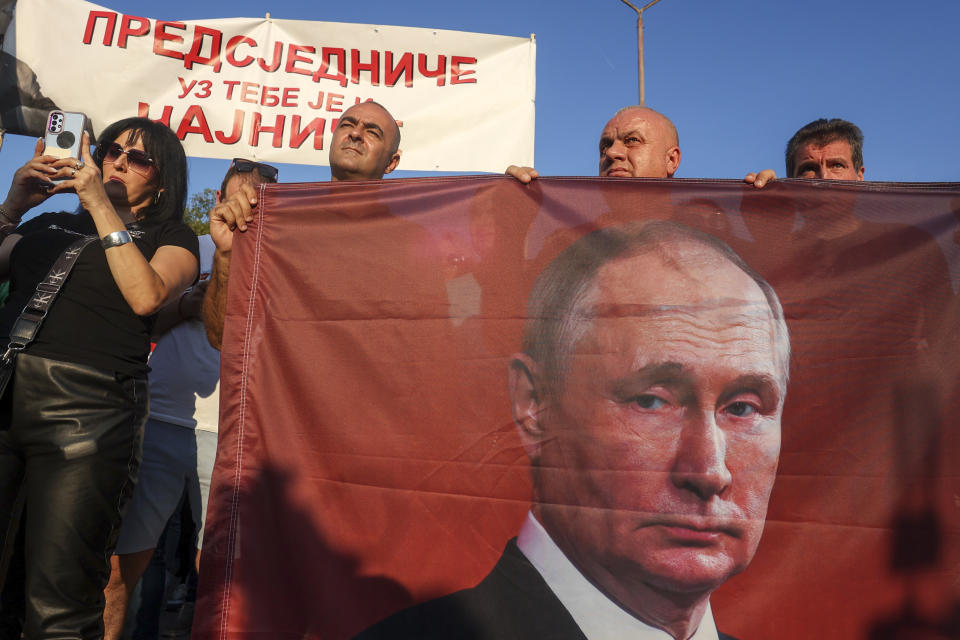 Protesters hold a flag depicting Russian President Vladimir Putin during a rally supporting Milorad Dodik, pro-Russian leader in Bosnia, in Lukavica, Bosnia, Friday, Sept. 1, 2023. Several hundreds of Serb supporters of Milorad Dodik, pro-Russian leader in Bosnia have gathered at several entity lines in Bosnia, demanding a stop to what they call illegal criminal persecution of their leadership by state prosecution. Carrying Russian flags with pictures of Russian president Putin, Serbs demanded that Bosnian state prosecution removes its indictment against Dodik which is accused of defying the decisions by international peace agreement over-seer Christian Schmidt. (AP Photo)