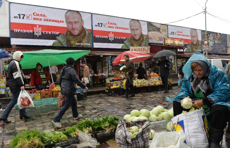 Billboards of the Right Sector, a far-right Ukrainian party, are set above shops on October 23, 2014 in the market in Lviv