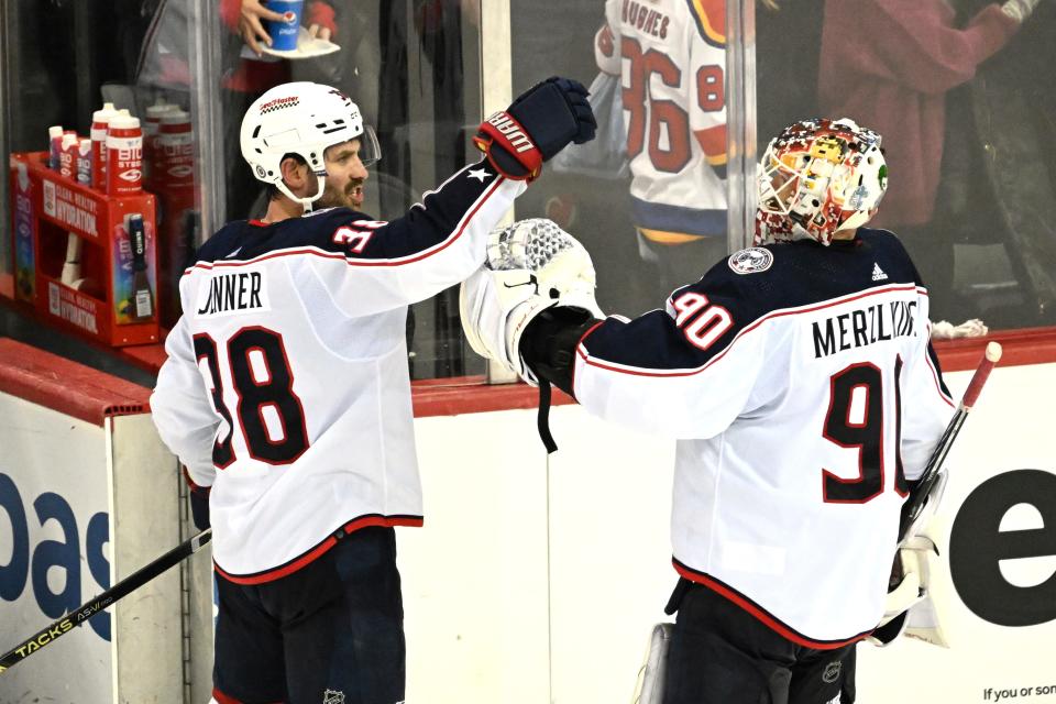 Columbus Blue Jackets center Boone Jenner (38) celebrates with goaltender Elvis Merzlikins (90) after they defeated the New Jersey Devils in an NHL hockey game Friday, Nov. 24, 2023, in Newark, N.J. (AP Photo/Bill Kostroun)