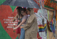 <p>Madison Fisher, Sarah Partenio and Immanuelle Craan (L-R) visit the memorial to the victims of the mass shooting setup around the Pulse gay nightclub one day before the one year anniversary of the shooting on June 11, 2017 in Orlando, Florida. (Joe Raedle/Getty Images) </p>