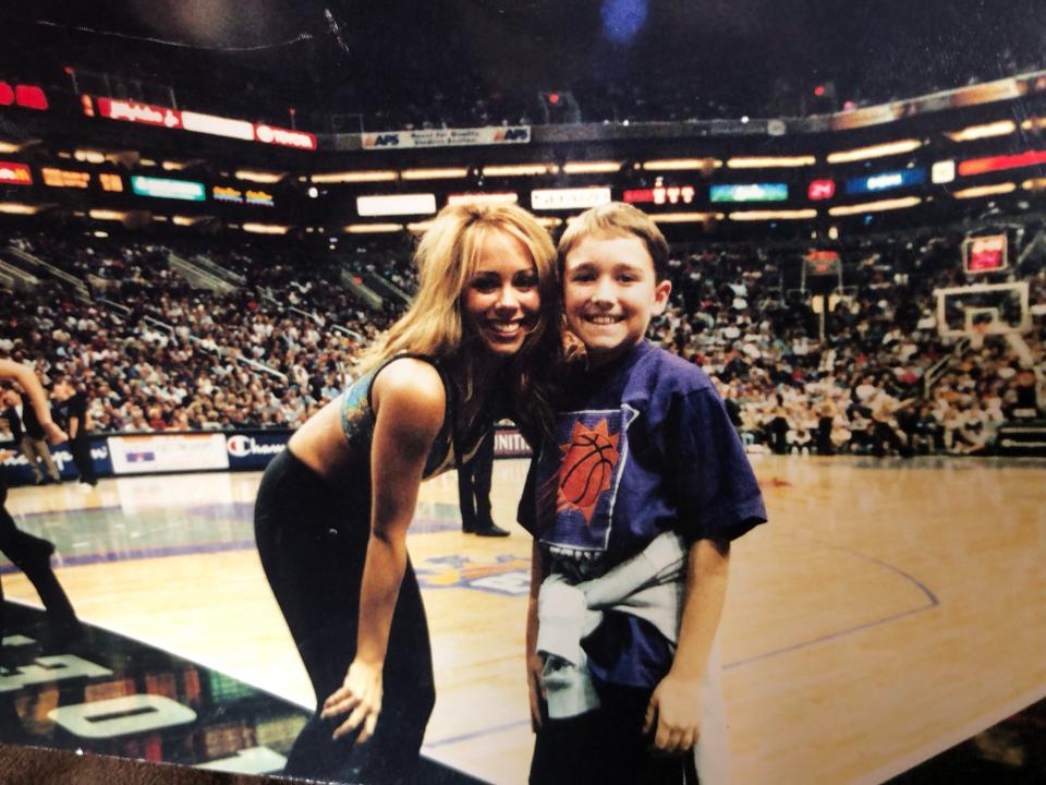 A Phoenix Suns dancer poses with young fan Ben Leibowitz.