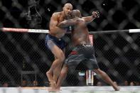 Ciryl Gane, left, and Derrick Lewis, right, compete during their interim heavyweight mixed martial arts title bout at UFC 265 on Saturday, Aug. 7, 2021, in Houston. (AP Photo/Michael Wyke)