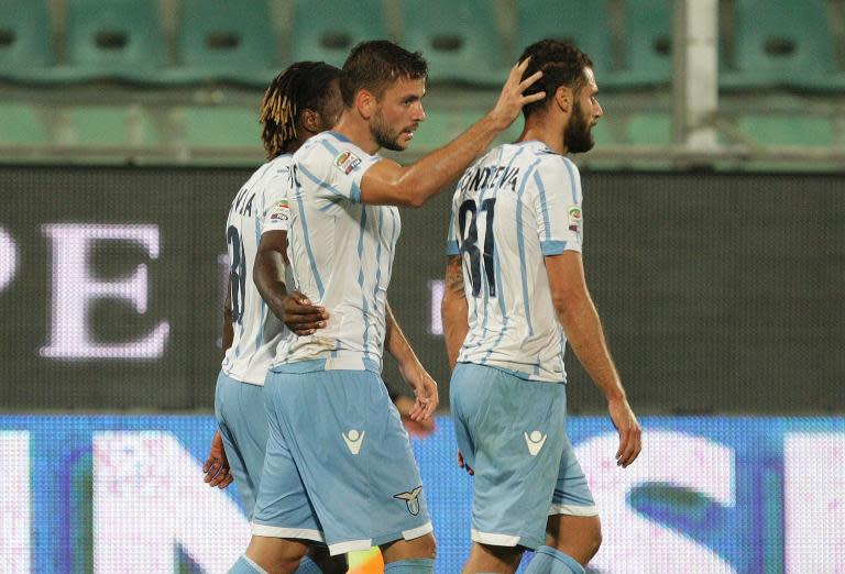 Lazio's Filip Djordjevic (C) celebrates with teammates after scoring a goal during their Italian Serie A match against Palermo, in Palermo, on September 29, 2014