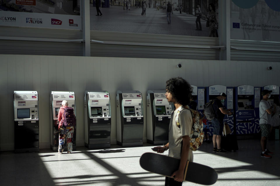 A passenger walks in the Part-Dieu train station during a railway strike, in Lyon, central France, Wednesday, July 6, 2022. A strike by railway workers demanding higher pay amid cost of living increases is interrupting train service in France. National railway company SNCF said about one in four high-speed trains was canceled on Wednesday. It says regional service such as suburban trains in the Paris region is experiencing disruptions. (AP Photo/Laurent Cipriani)