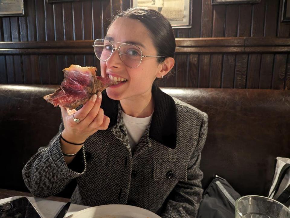 Rachel Askinasi biting into steak 