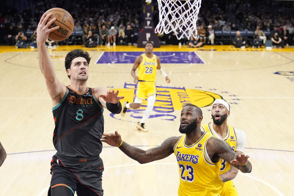 Washington Wizards forward Deni Avdija, left, shoots as Los Angeles Lakers forward LeBron James, center, and forward Anthony Davis defend during the first half of an NBA basketball game Thursday, Feb. 29, 2024, in Los Angeles. (AP Photo/Mark J. Terrill)