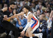 Detroit Pistons guard Cade Cunningham, right, drives to the basket as Denver Nuggets guard Jamal Murray, left, defends in the first half of an NBA basketball game Sunday, Jan. 7, 2024, in Denver. (AP Photo/David Zalubowski)