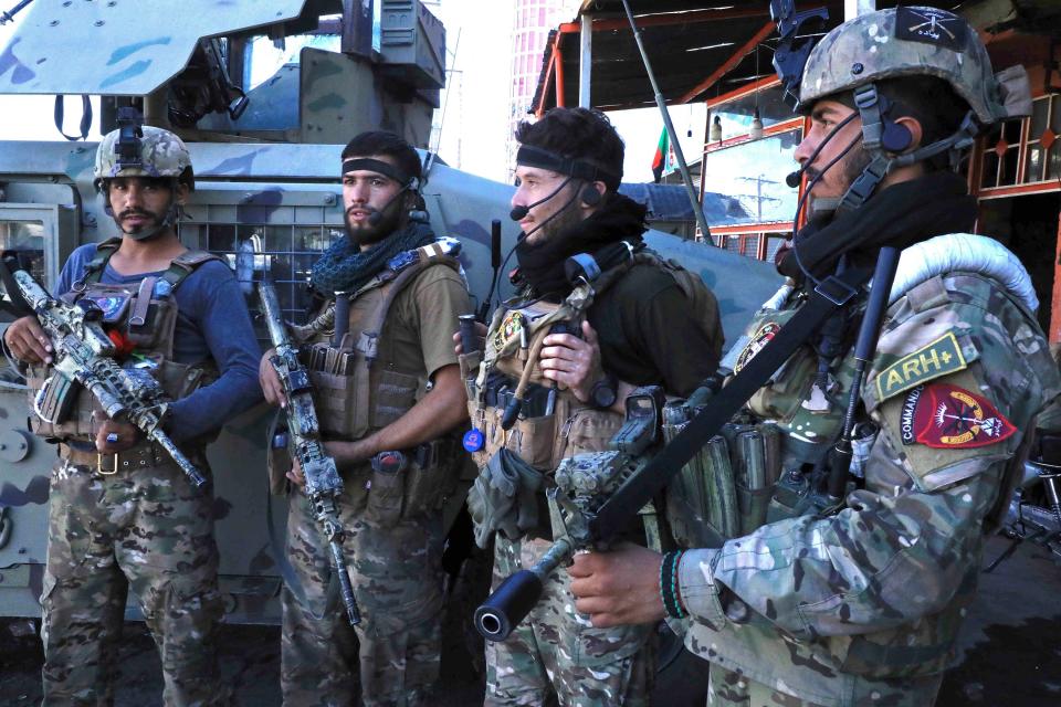 Afghan security force personnel stand guard along the roadside in Herat on August 12, 2021, as Taliban took over the police headquarters in Herat, Afghanistan's third-largest city.