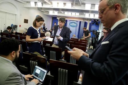 Journalists work in the briefing room at the White House in Washington, U.S., February 24, 2017. REUTERS/Yuri Gripas