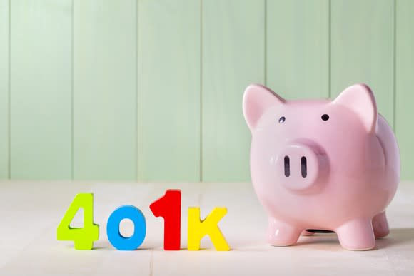 401k in colorful letters next to a piggy bank.