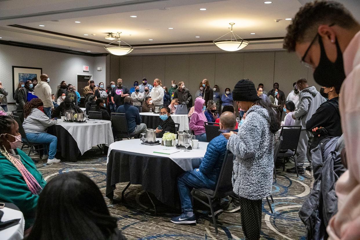Family and friends wait for word of their loved ones who were at the FedEx Ground facility during a shooting in Indianapolis, Thursday night, April 15, 2021.