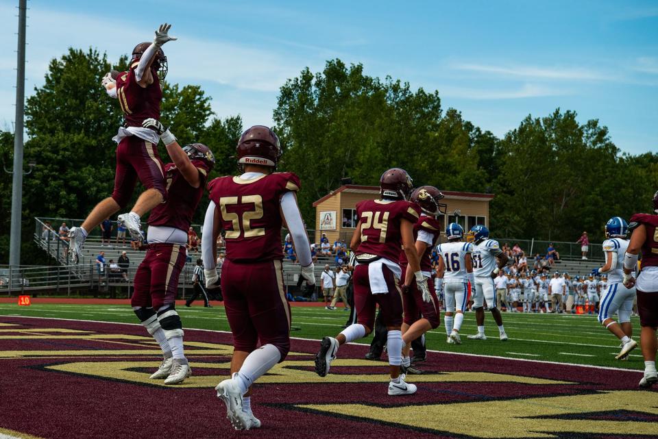 Arlington's James Davenport celebrates a touchdown with a teammate during the week 0 high school football game at Arlington High School in Freedom Plains, NY on Saturday, September 2, 2023. Arlington defeated Kellenberg 49-21.