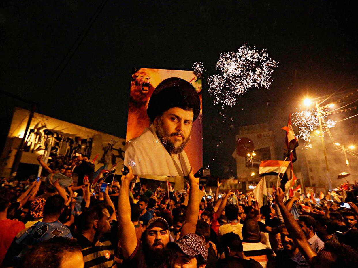 Followers of Shia cleric Muqtada al-Sadr celebrate in Tahrir Square, Baghdad: AP