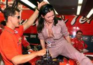 <p>The F1 fans will appreciate this one: German racer Michael Schumacher helps Kate Moss get into his Ferrari in Monte Carlo, Monaco, in 1999. Drivers will invest so much time and money on their automobiles, so you could say it’s a luxury sport. With luxury sports come supermodels, right?</p>
