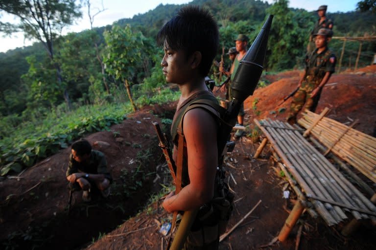 Soldiers from the All Burma Students Democratic Front - Northern Burma (ABSDF-NB), an ally of the Kachin Independence Army (KIA), pictured with their weapons at an outpost on the Laja Yang frontline, in Myanmar's northern Kachin state, on September 22, 2012