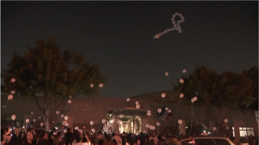 Mourners release balloons into the sky to honor the 14-year-old victim in Cudahy