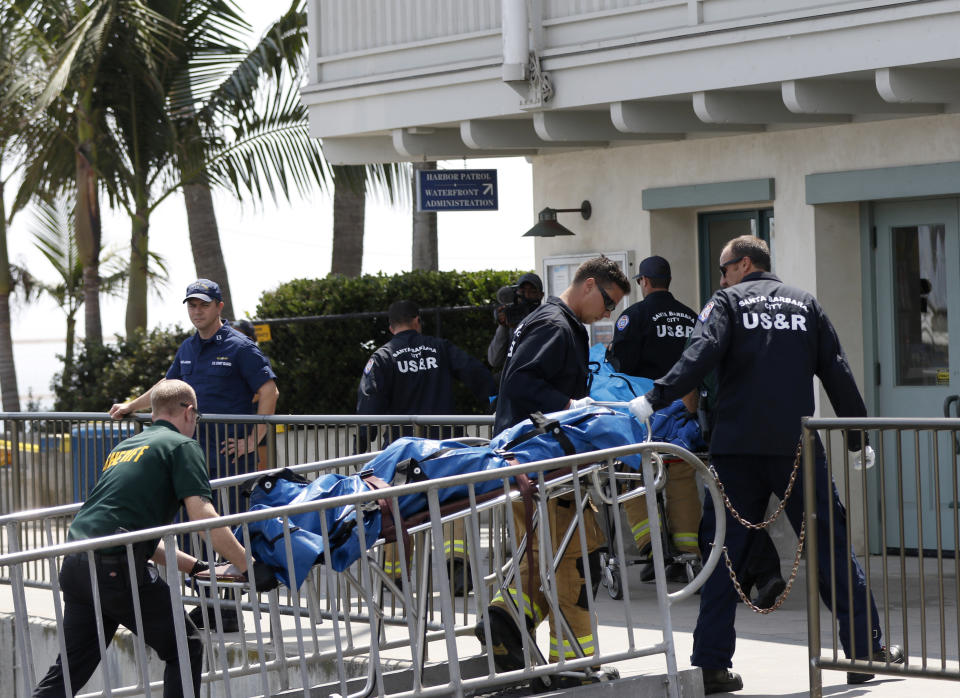 Santa Barbara City Search and Rescue along with Santa Barbara Sheriff's officers move a recovered body on the dock at Santa Barbara Harbor in Santa Barbara, Calif., Monday, Sept. 2, 2019. The body was recovered from a dive boat fire near Santa Cruz Island early Monday. (AP Photo/Daniel Dreifuss)