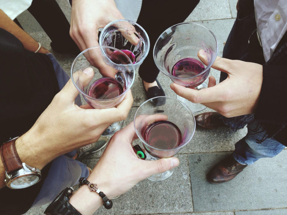 People holding wine on the street