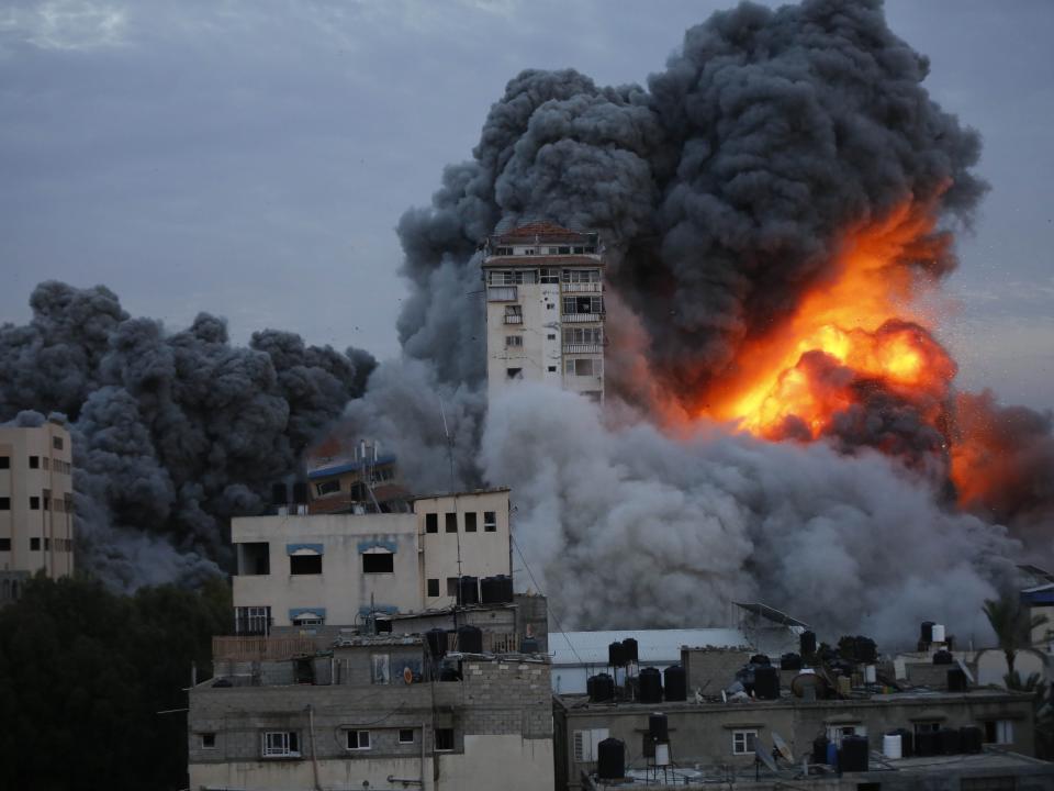 Smoke and flame rise after Israeli air forces targeting a shopping center in Gaza Strip, Gaza on October 07, 2023.