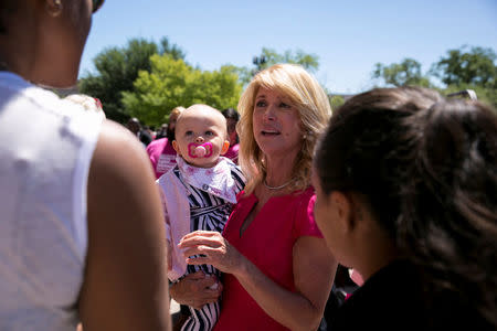 Former Texas State Senator Wendy Davis with her granddaughter Ellis Davis-Erdell, 11 months, after a Planned Parenthood rally outside the State Capitol in Austin, Texas, April 5, 2017. REUTERS/Ilana Panich-Linsman
