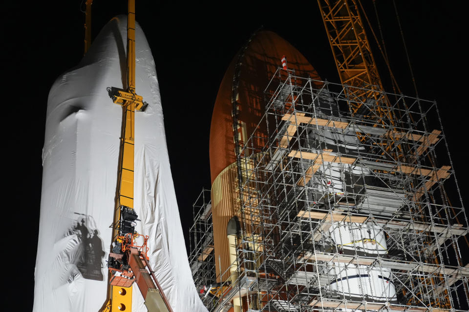 Space Shuttle Endeavour is lifted into the site of the future Samuel Oschin Air and Space Center on Tuesday, Jan. 30, 2024, in Los Angeles. (AP Photo/Ashley Landis)