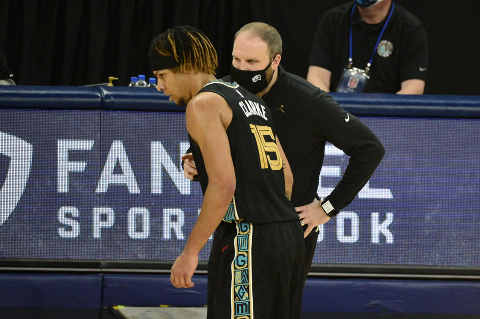 Memphis Grizzlies head coach Taylor Jenkins, front right, talks with forward Brandon Clarke (15) in the first half of an NBA basketball game against the Phoenix Suns, Monday, Jan. 18, 2021, in Memphis, Tenn. (AP Photo/Brandon Dill)