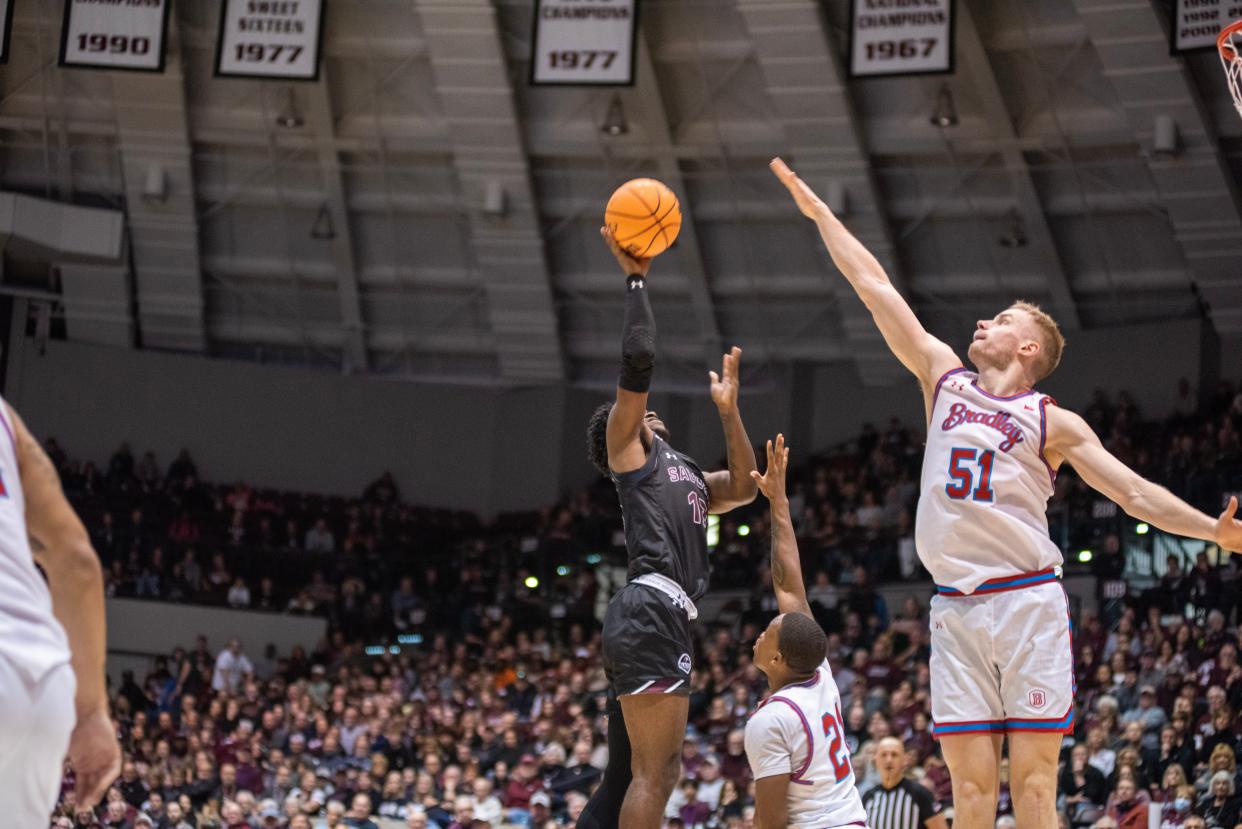 Bradley center Rienk Mast tries to block a shot by Jawaun Newton during the Braves 50-48 win over Southern Illinois at Banterra Center in Carbondale on Sunday, Feb. 19, 2023.