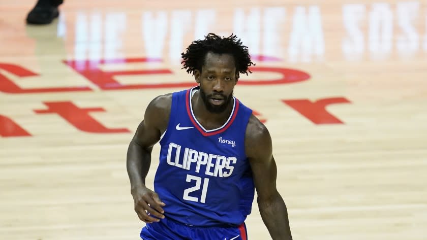 Los Angeles Clippers guard Patrick Beverley (21) controls the ball during the first quarter of an NBA basketball game against the Sacramento Kings Wednesday, Jan. 20, 2021, in Los Angeles. (AP Photo/Ashley Landis)