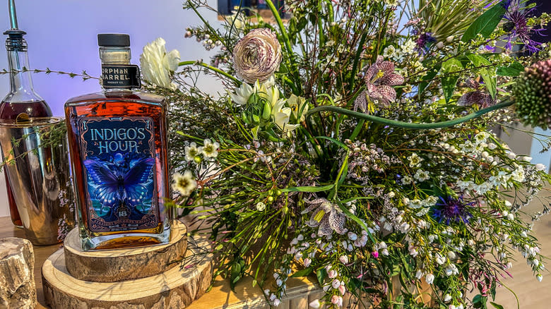 Indigo's Hour bottle with flowers
