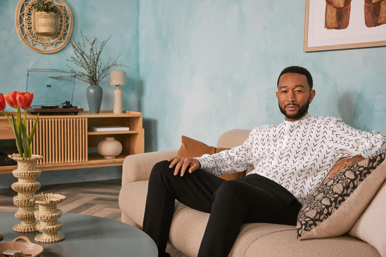  A man sat on a sofa in a living room 