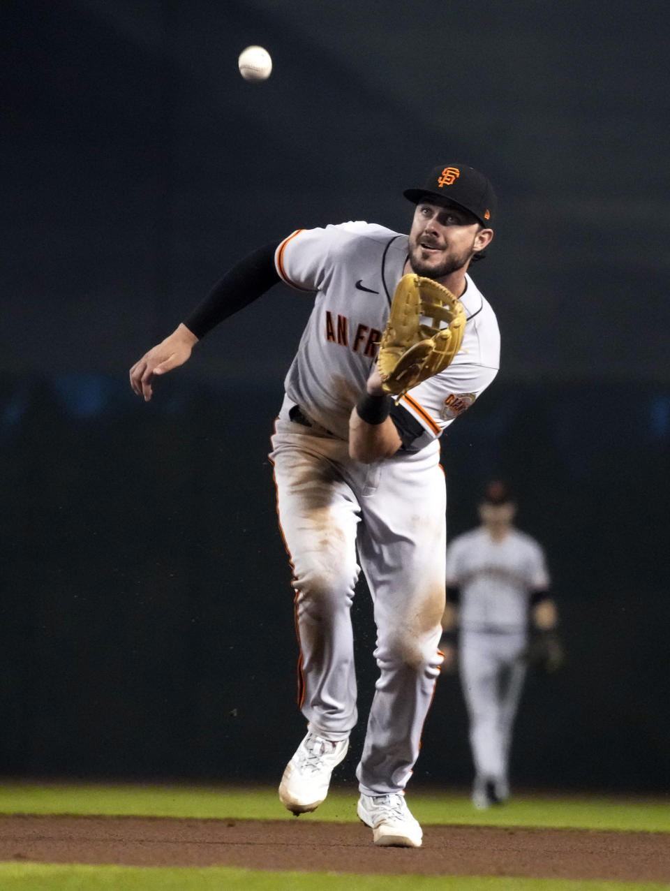 San Francisco Giants third baseman Kris Bryant makes the play for an out on a ball hit by Arizona Diamondbacks' David Peralta in the fourth inning during a baseball game, Monday, Aug 2, 2021, in Phoenix. (AP Photo/Rick Scuteri)