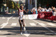 <p>Peres Jepchirchir of Team Kenya celebrates as she crosses the finish line to win the gold medal in the Women's Marathon Final. </p>