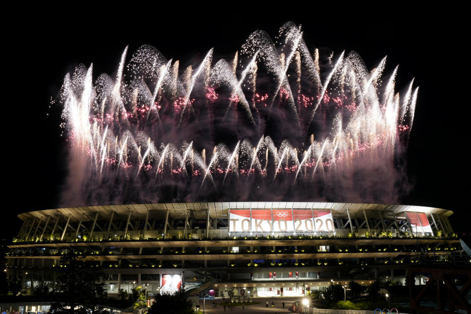 FILE - In this July 23, 2021, file photo, fireworks illuminate over the National Stadium during the opening ceremony of the 2020 Summer Olympics in Tokyo. The price tag for the Tokyo Olympics is $15.4 billion. Tokyo built eight new venues. The two most expensive were the National Stadium, which cost $1.43 billion, and the new aquatic center, priced a $520 million. (AP Photo/Shuji Kajiyama, File)