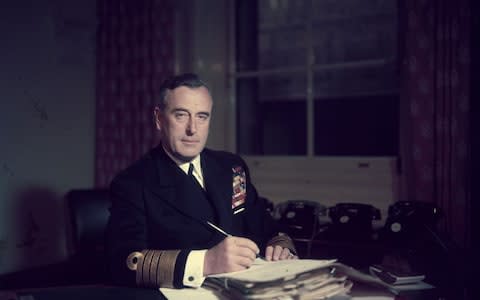 First Sea Lord Louis Mountbatten, Earl Mountbatten, at his office in the Admiralty, in 1955 - Credit: Hulton Royals Collection/Hulton Archive