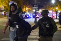 Police take an individual into custody Friday, Oct. 9, 2020, in Wauwatosa, Wis. On Wednesday, District Attorney John Chisholm refused to issue charges against Wauwatosa Police Officer Joseph Mensah for the Feb. 2 fatal shooting of 17-year-old Alvin Cole at Mayfair Mall. (AP Photo/Morry Gash)