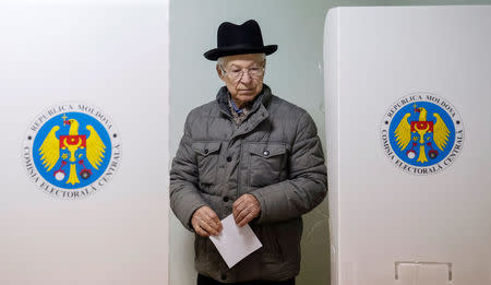 A man leaves a booth before casting his vote during a presidential election at a polling station in Chisinau, Moldova, October 30, 2016. REUTERS/Gleb Garanich