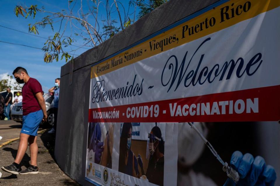 People stand in line as they wait to be inoculated with the Moderna Covid-19 vaccine at a K-5 school in Vieques, Puerto Rico in March 2021. (Ricardo Arduengo / Getty Images)