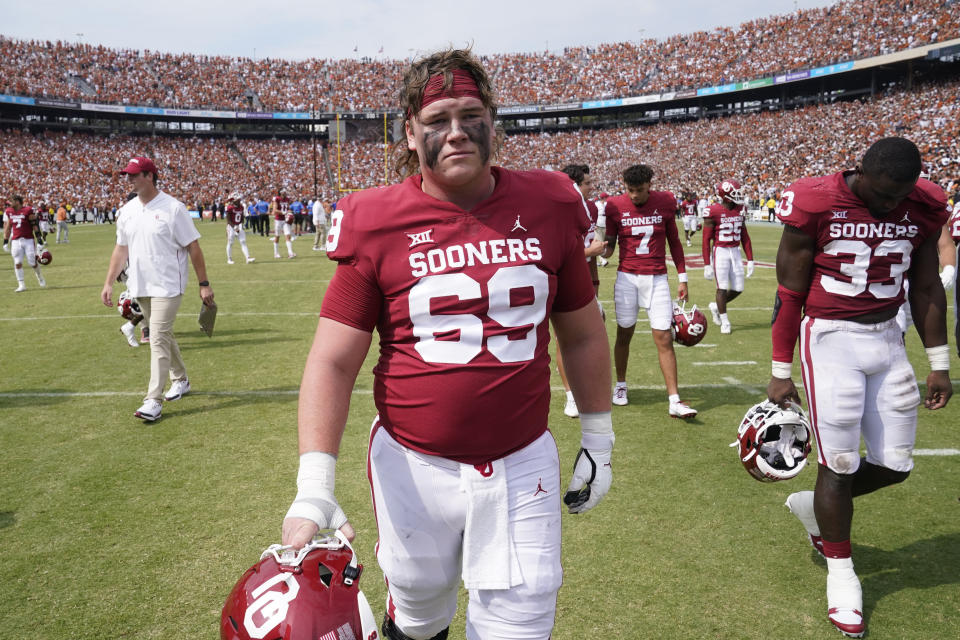 FILE - Oklahoma offensive lineman Nate Anderson (69) walks off the the field with with teammates after losing to Texas 49-0 in an NCAA college football game at the Cotton Bowl in Dallas, Saturday, Oct. 8, 2022. Oklahoma was selected the most disappointing team in the Associated Press Big 12 Midseason Awards, Tuesday, Oct. 11, 2022.(AP Photo/LM Otero, File)