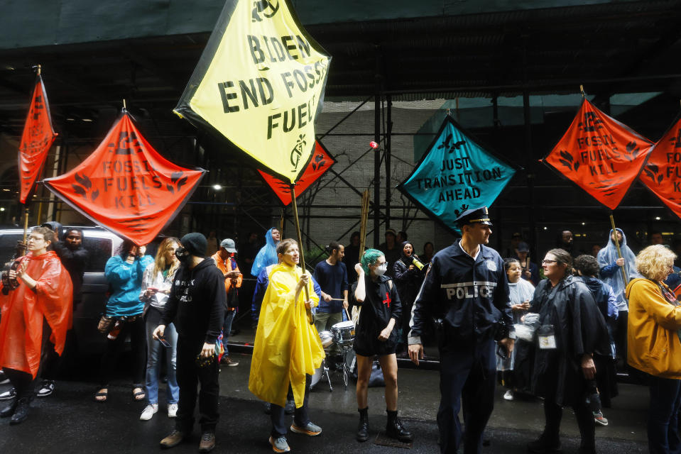 Climate activists protest outside the Federal Reserve Bank of New York to call for an end to the use of fossil fuels, Monday, Sept. 18, 2023, in New York. (AP Photo/Jason DeCrow)