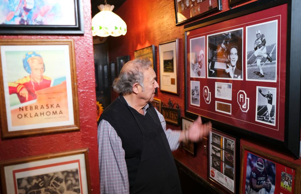 Owner Greg Gawey shows off some of the history on the walls of Jamil's Steakhouse on April 4.