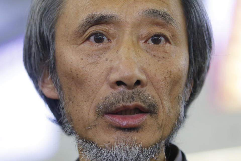 Chinese dissident writer Ma Jian speaks to media after arriving Hong Kong international airport, Friday, Nov. 9, 2018. Hong Kong on Friday permitted dissident writer Ma to enter to attend a literary festival, even after an arts venue in the city canceled his appearance. Ma, whose novels frequently satirize China's communist leaders, told reporters he experienced nothing unusual while passing through passport control and that organizers were still lining-up a place for him to speak. "The lecture will definitely happen. If there is a single Hong Kong person who is willing to listen, or a single reader who contacts me, I will be there," Ma said. (AP Photo/Kin Cheung)