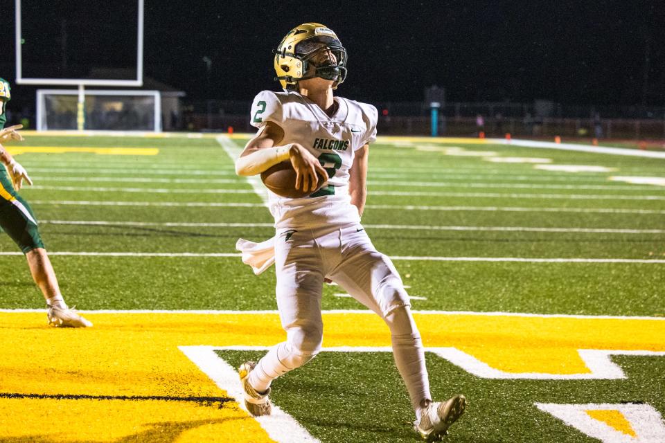 SMCC quarterback Ian Foster celebrates after scoring a touchdown against Flat Rock during a 27-18 SMCC win Friday night.