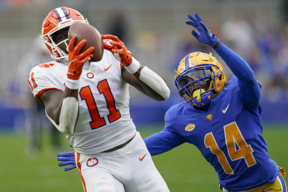 Clemson wide receiver Ajou Ajou (11) makes a catch for a first down in front of Pittsburgh defensive back Marquis Williams (14) during the first half of an NCAA college football game, Saturday, Oct. 23, 2021, in Pittsburgh. (AP Photo/Keith Srakocic)