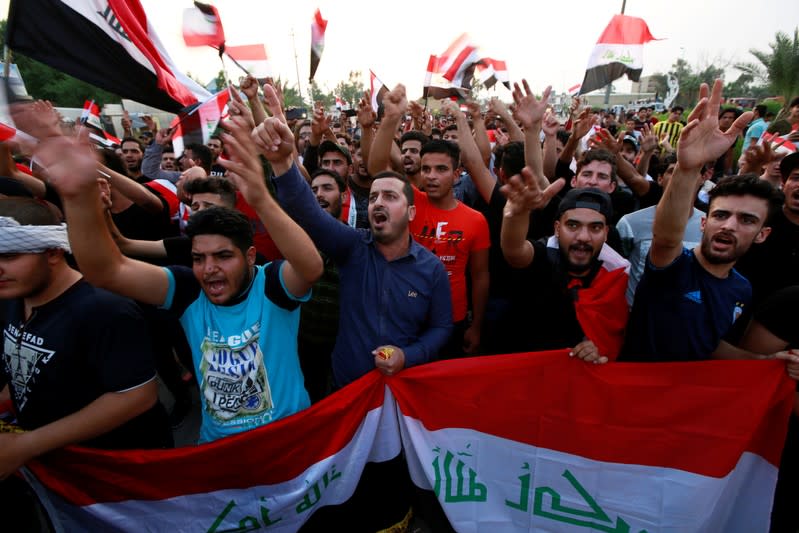 Demonstrators chant slogans during a protest over corruption, lack of jobs, and poor services, in Najaf