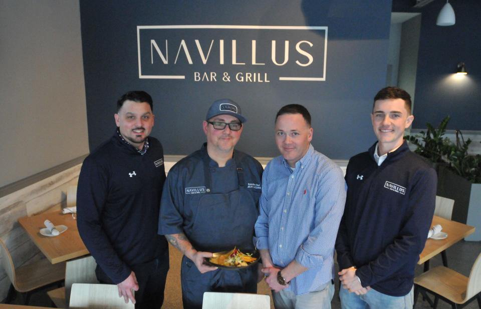 Co-owner Sam O'Connor, executive chef Julio Lazzarini, owner Sean Sullivan and bar manager Will Belscher, left to right, make up some of the management and staff at Navillus Bar & Grill. Lazzarini is holding the ceviche appetizer. Navillus Bar & Grill has opened in the space Guapo's used to occupy in the Orleans Marketplace.