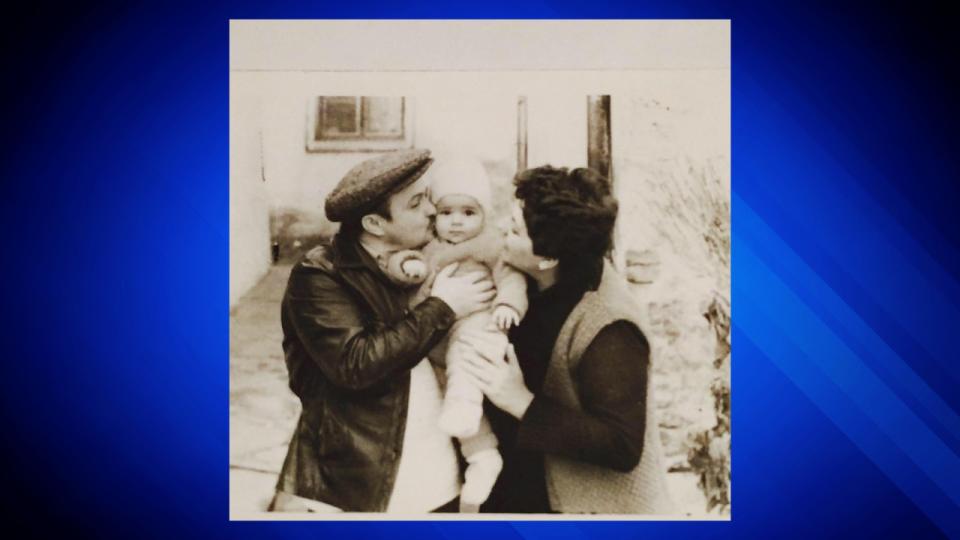 Ana Walshe is shown as a baby in this undated photo, which she posted on Facebook, being held by an unidentified man and woman in her native Serbia. (Facebook photo)
