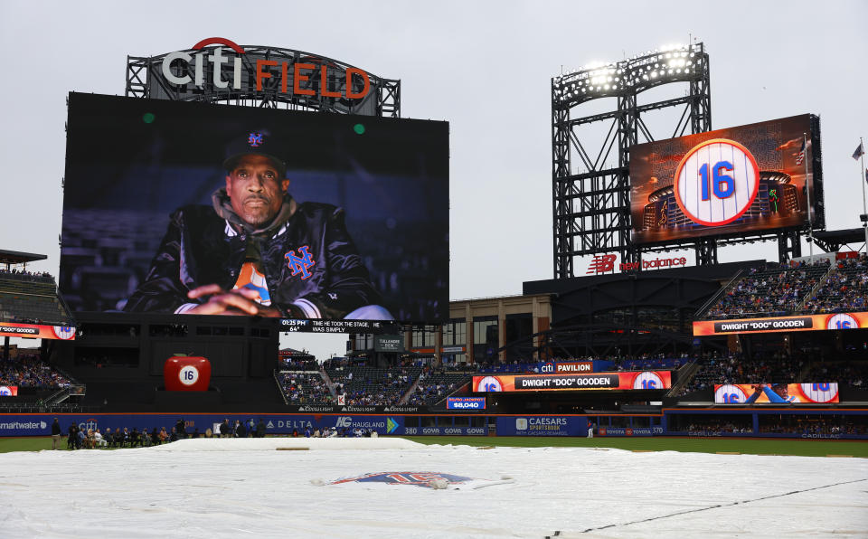 Former New York Mets pitcher Dwight Gooden appears on the scoreboard before a ceremony to retire his No. 16 at Citi Field before a baseball game between the Mets and the Kansas City Royals, Sunday, April 14, 2024, in New York. (AP Photo/Noah K. Murray)